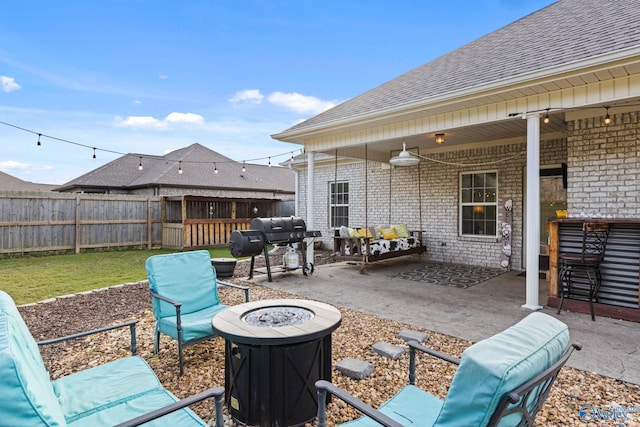 view of patio featuring an outdoor living space with a fire pit and a grill