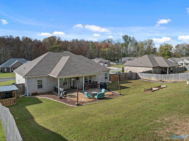 back of house with a yard and a patio area