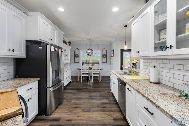 kitchen with stainless steel appliances, white cabinetry, sink, decorative light fixtures, and dark wood-type flooring