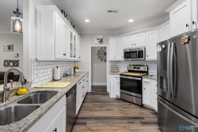 kitchen with white cabinets, appliances with stainless steel finishes, sink, and dark hardwood / wood-style floors