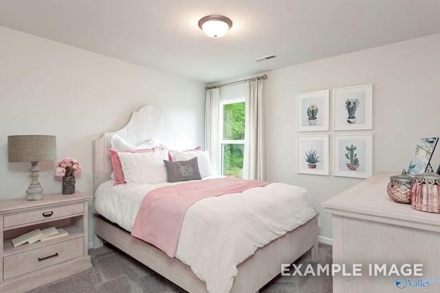 bedroom with dark colored carpet