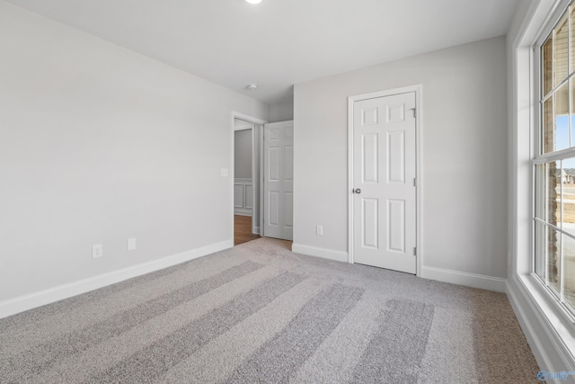 unfurnished bedroom featuring baseboards and carpet flooring