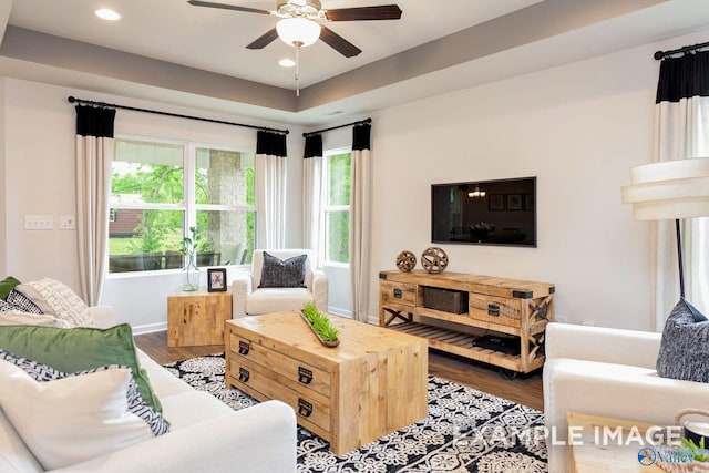 living area featuring baseboards, a ceiling fan, wood finished floors, and recessed lighting