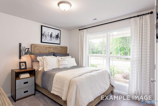 carpeted bedroom featuring visible vents and baseboards