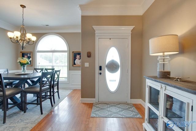 16675 Bellewood Dr, Athens, AL 35613 - entryway with a chandelier, light wood-style flooring, ornamental molding, and a wainscoted wall