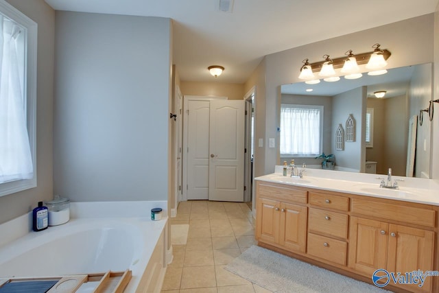 16675 Bellewood Dr, Athens, AL 35613 - full bathroom with double vanity, tile patterned floors, a garden tub, and toilet