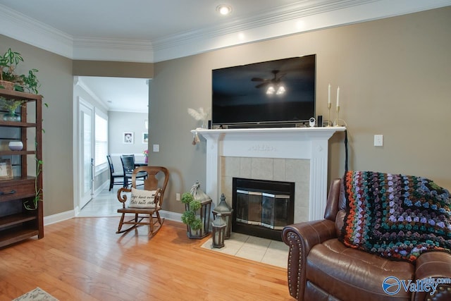 16675 Bellewood Dr, Athens, AL 35613 - living room featuring wood finished floors, crown molding, a tiled fireplace, baseboards, and recessed lighting