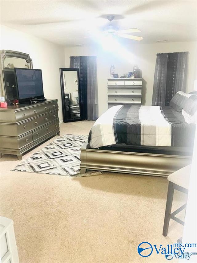 carpeted bedroom featuring ceiling fan