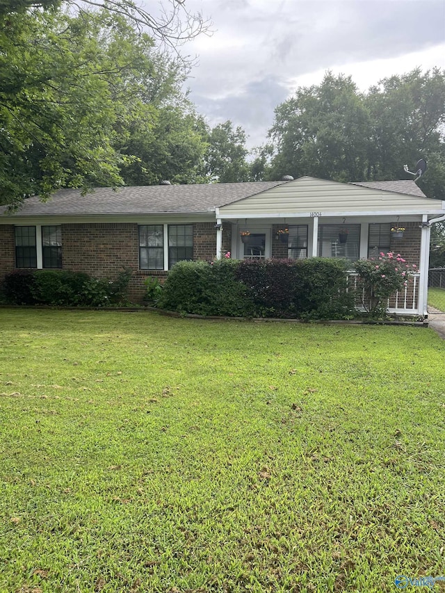 14004 Hurstland Dr SW, Huntsville, AL 35803 - view of front of house featuring brick siding, a front lawn, and roof with shingles