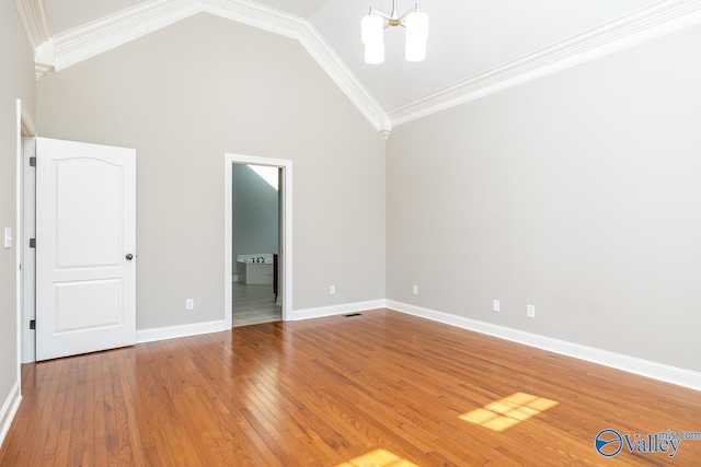 unfurnished bedroom featuring high vaulted ceiling, wood-type flooring, ornamental molding, a notable chandelier, and ensuite bath