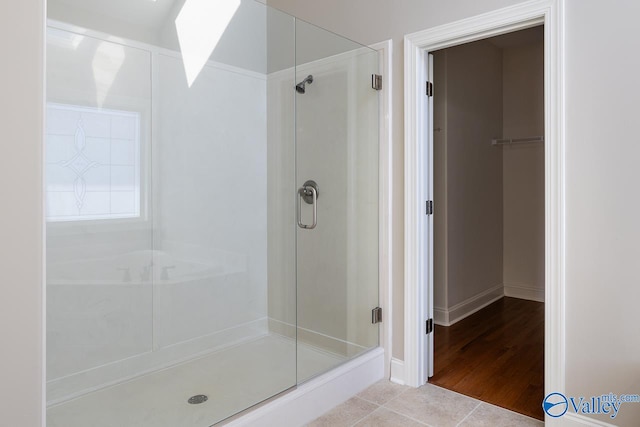 bathroom featuring hardwood / wood-style flooring and walk in shower