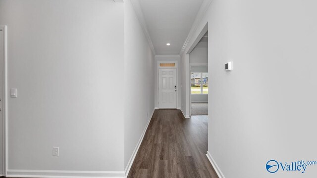 hall with hardwood / wood-style flooring and ornamental molding