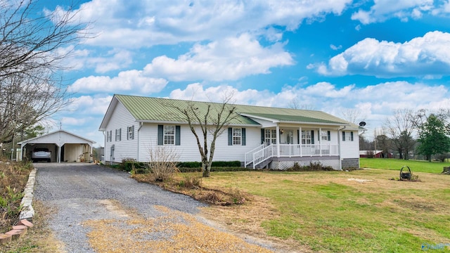 ranch-style house with a porch, a garage, an outdoor structure, and a front lawn