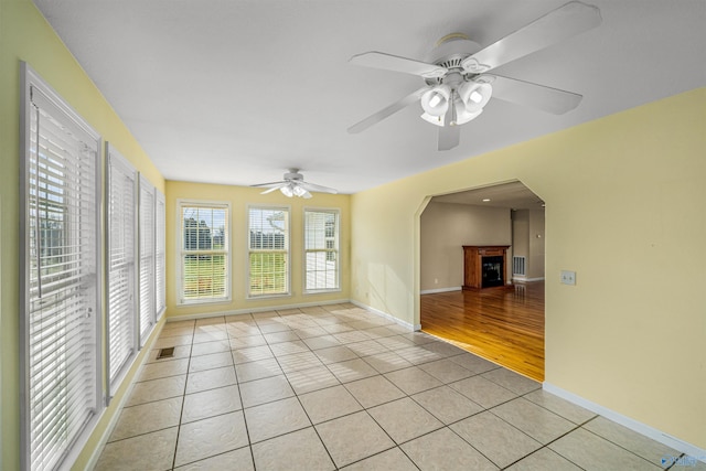 empty room featuring ceiling fan and light tile patterned floors