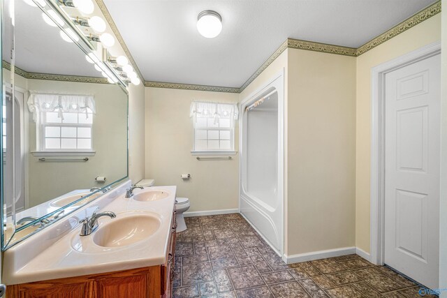 bathroom featuring plenty of natural light, vanity, and toilet