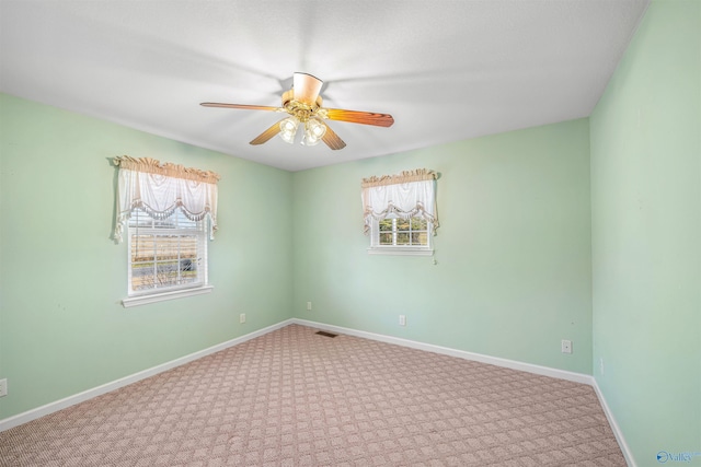 carpeted empty room featuring ceiling fan