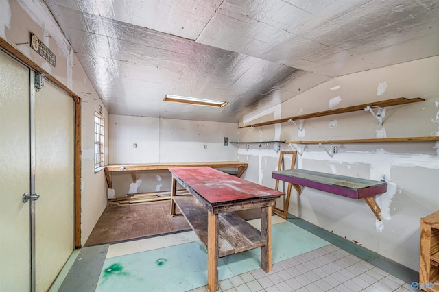 dining space with a workshop area and lofted ceiling