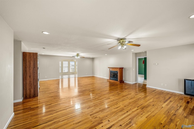 unfurnished living room featuring light hardwood / wood-style floors and ceiling fan