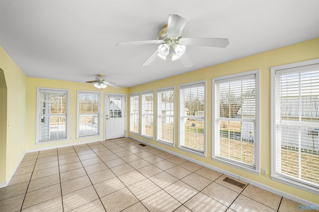 unfurnished sunroom with ceiling fan