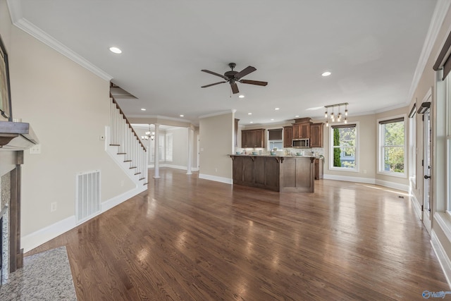 unfurnished living room with crown molding, baseboards, visible vents, and recessed lighting