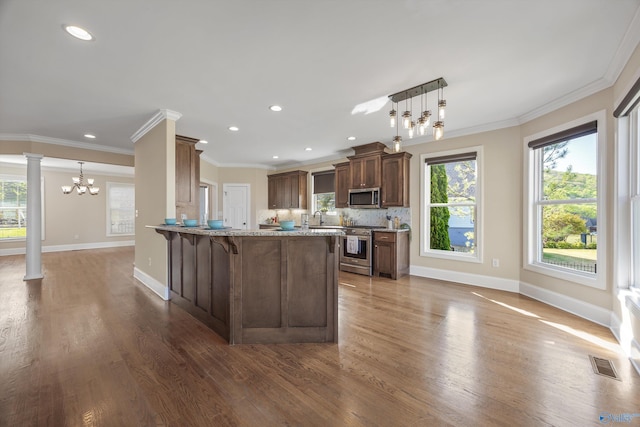 kitchen featuring visible vents, baseboards, appliances with stainless steel finishes, and an inviting chandelier