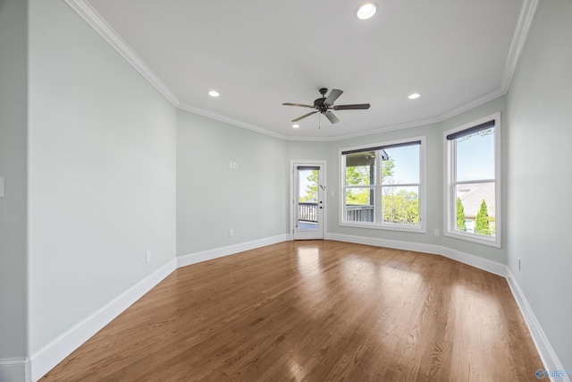 empty room with ornamental molding, baseboards, recessed lighting, and wood finished floors