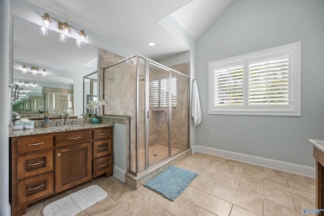 full bath with a shower stall, vanity, and lofted ceiling