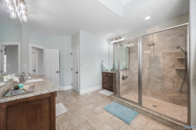 bathroom featuring a shower stall, vanity, and baseboards
