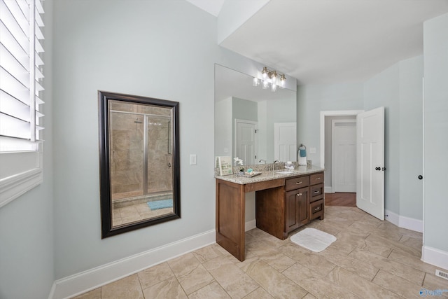 bathroom featuring vanity, baseboards, and visible vents