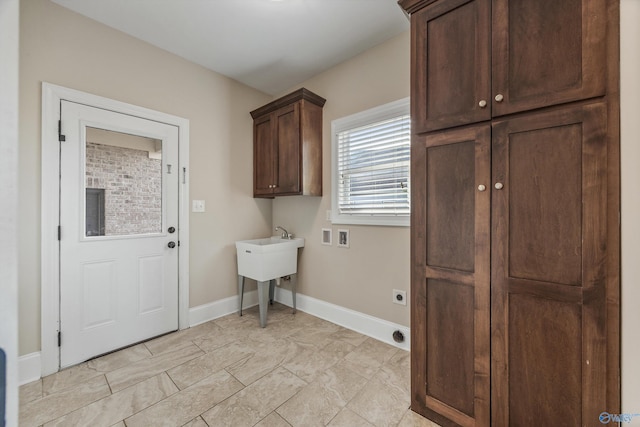 washroom with baseboards, hookup for a washing machine, electric dryer hookup, and cabinet space