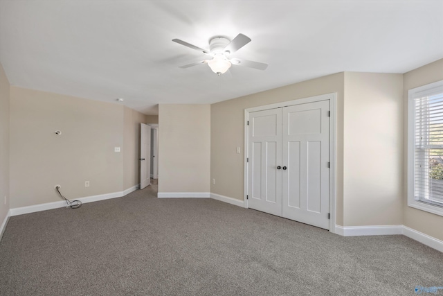 unfurnished bedroom featuring carpet floors, baseboards, and ceiling fan