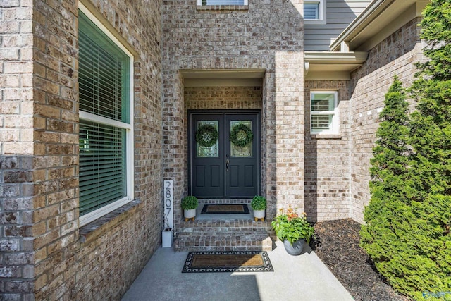 doorway to property featuring brick siding