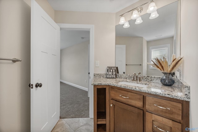 bathroom featuring tile patterned floors, vanity, and baseboards