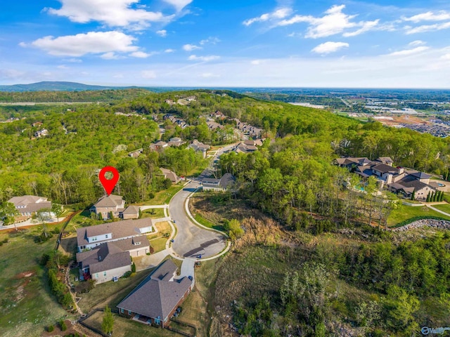 aerial view featuring a wooded view and a residential view