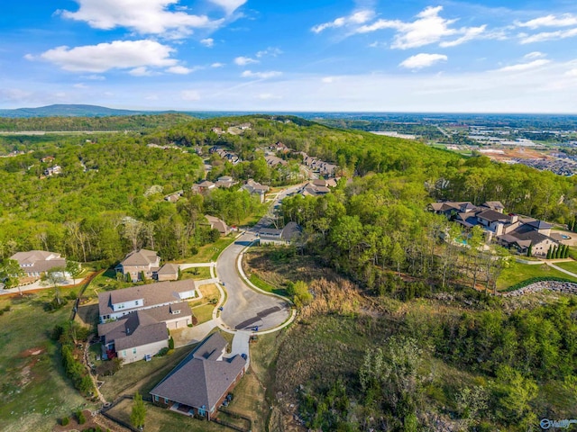 birds eye view of property with a forest view and a residential view