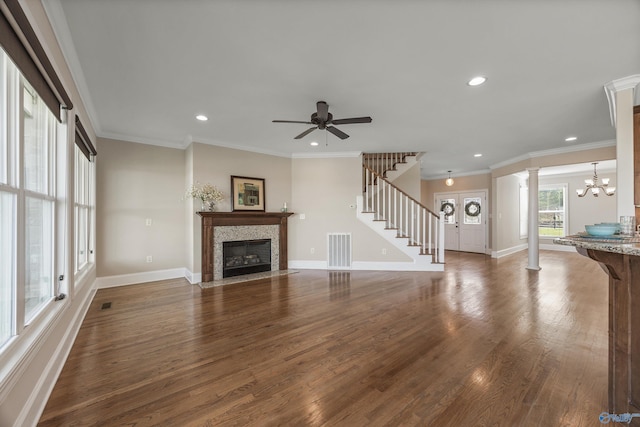 unfurnished living room featuring decorative columns, a fireplace with flush hearth, visible vents, stairway, and recessed lighting