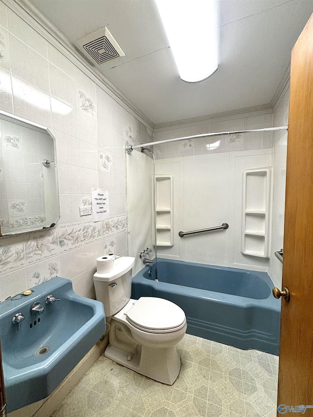 312 8th Ave SW, Attalla, AL 35954 - full bathroom featuring toilet, shower / tub combination, ornamental molding, a sink, and tile walls