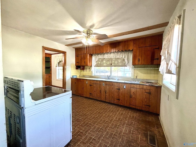 312 8th Ave SW, Attalla, AL 35954 - kitchen featuring brown cabinetry, tasteful backsplash, brick patterned floors, and a ceiling fan
