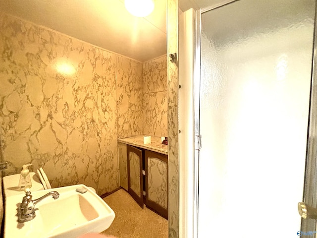 312 8th Ave SW, Attalla, AL 35954 - bathroom featuring a sink, a shower stall, and wallpapered walls