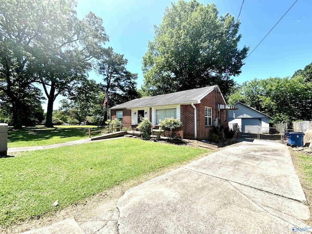 312 8th Ave SW, Attalla, AL 35954 - view of front of home with brick siding, a front lawn, an outbuilding, and driveway