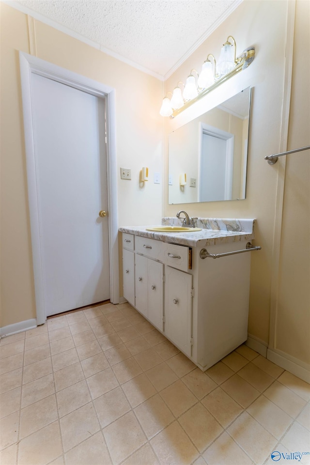 bathroom featuring crown molding, a textured ceiling, tile patterned floors, and vanity