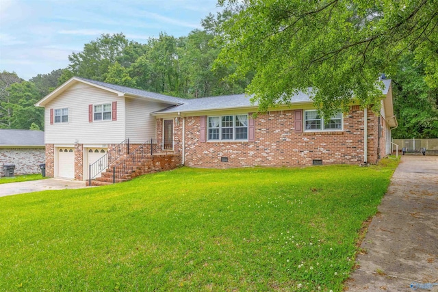 tri-level home featuring an attached garage, driveway, a front lawn, and brick siding