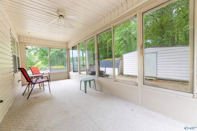 sunroom / solarium featuring ceiling fan