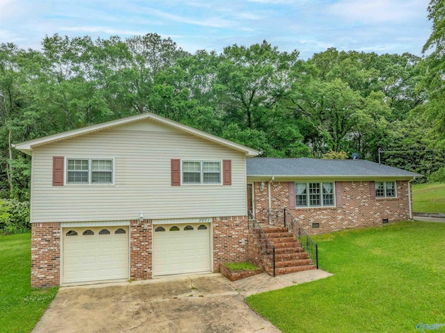 split level home with brick siding, driveway, a front yard, and a garage