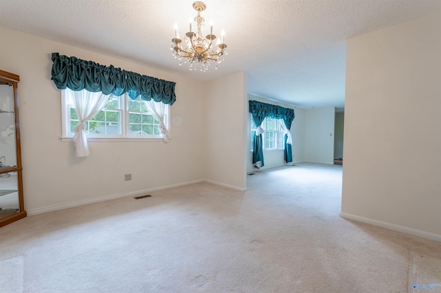 interior space featuring carpet floors, a wealth of natural light, a notable chandelier, and visible vents