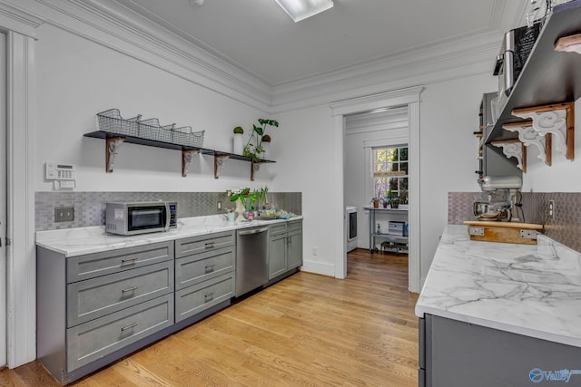 kitchen featuring light wood-type flooring, decorative backsplash, ornamental molding, and stainless steel appliances