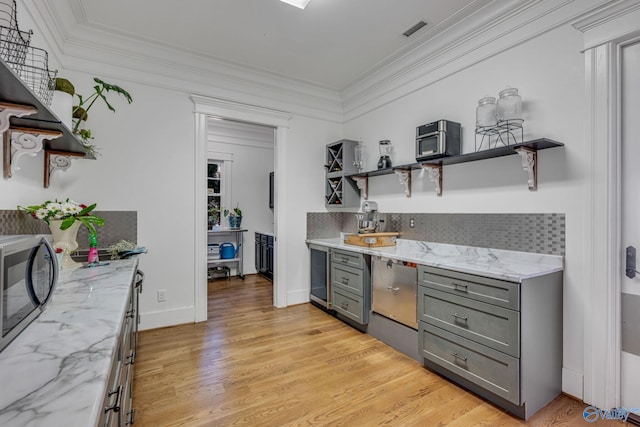 bar featuring light hardwood / wood-style floors, light stone countertops, crown molding, and tasteful backsplash