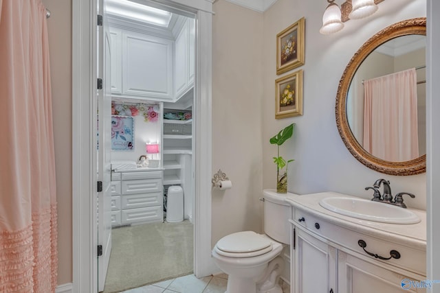 bathroom with toilet, vanity, tile patterned flooring, and crown molding