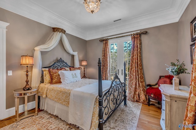 bedroom with french doors, access to exterior, light hardwood / wood-style floors, and crown molding