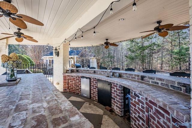 view of patio / terrace with an outdoor kitchen and an outdoor wet bar